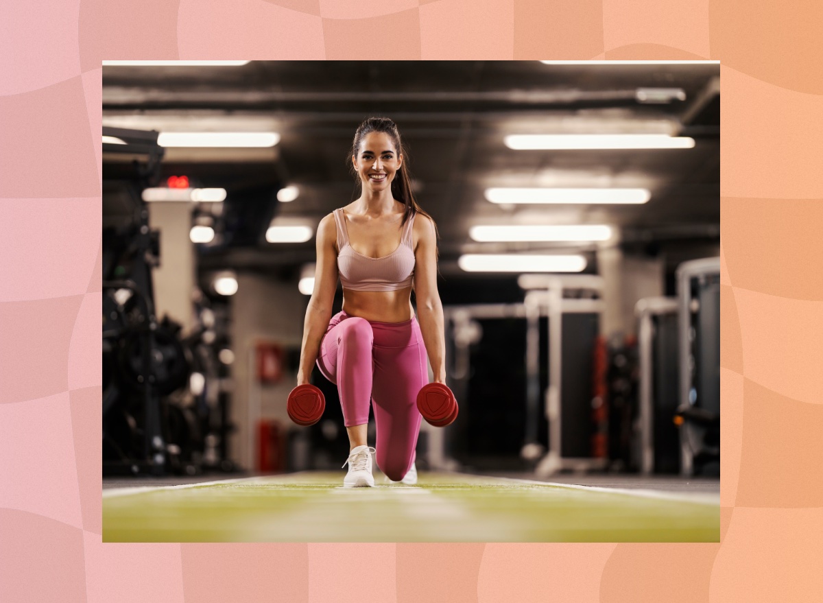 fit brunette woman doing dumbbell lunges at the gym