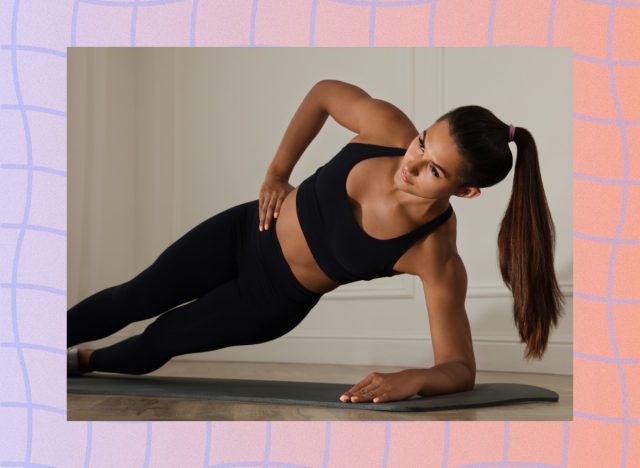 fit woman doing side plank exercise on mat