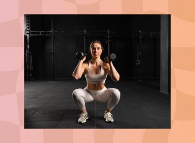 fit, focused woman doing squat to press exercise in dark gym