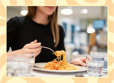 woman eating a plate of pasta