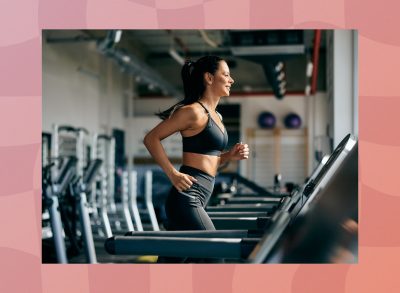 fit, focused brunette woman running on the treadmill at the gym