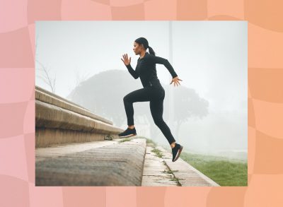 fit, focused woman doing stair runs outdoors on foggy day