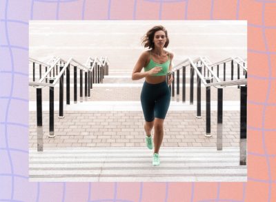 focused brunette woman running up stairs outdoors for exercise and cardio workout