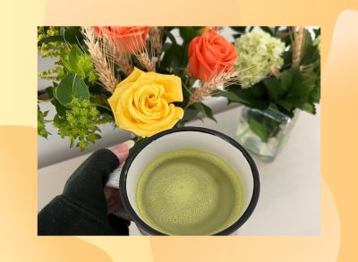 close-up of woman's hand holding cup of matcha