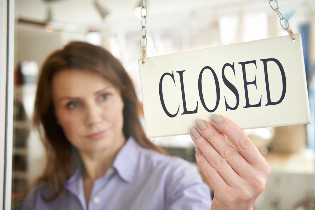 Store,Owner,Turning,Closed,Sign,In,Shop,Doorway