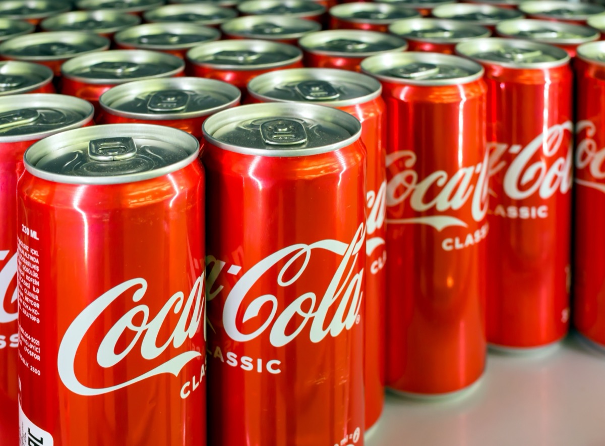 Voronezh - Russia, December 25, 2022: Background from cans with the drink "Coca Cola". (Shallow depth of field)