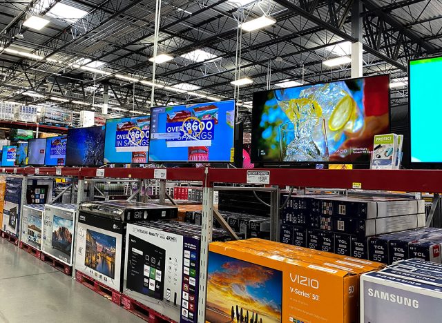 The TV aisle of a Sams Club Wholesale retail store with a variety of television ready to be purchased by consumers.