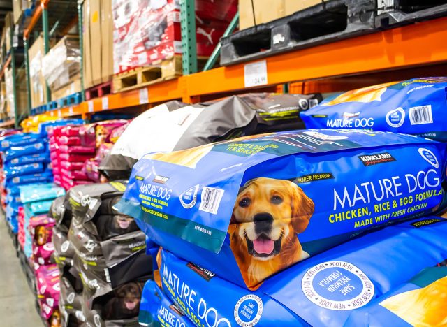 A view of the dog food section at Costco, featuring a package of Kirkland Signature Mature Dog pet food.