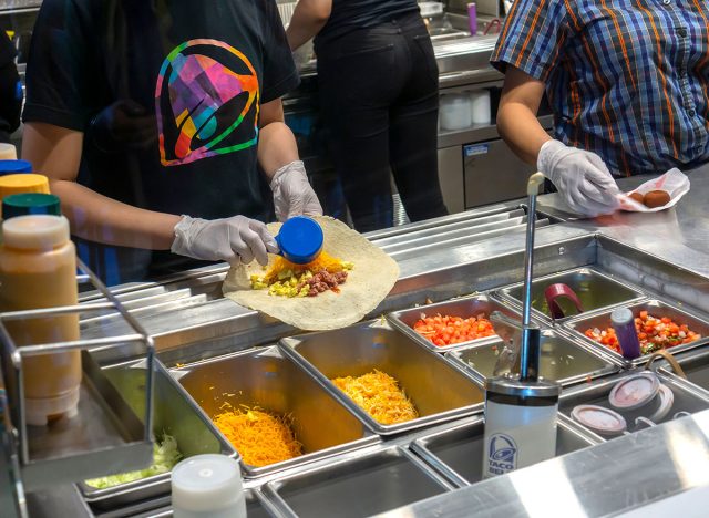 Workers prepare food in the Taco Bell Cantina restaurant in Midtown Manhattan in New York