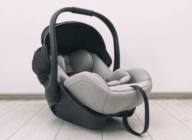 Empty baby car seat on the floor in the house