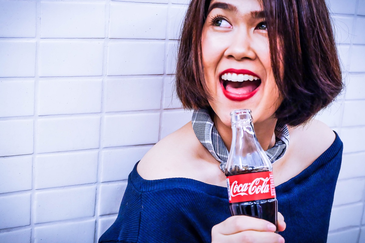 Woman with a bottle of Coca-Cola