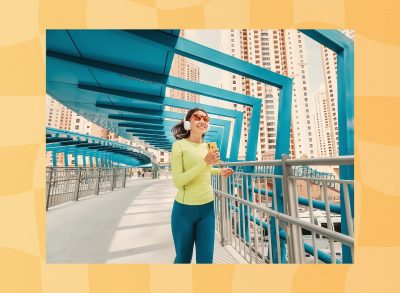 fit woman jogging across bridge for exercise