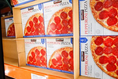 Los Angeles, California, United States - 07-22-2020: A view of several packages of Kirkland Signature pepperoni pizza, on display at a local Costco.