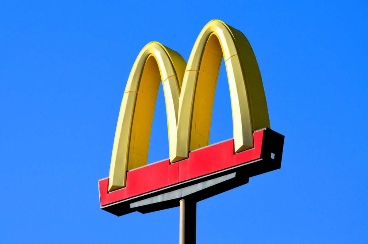 Phoenix, Arizona - Dec. 01 2023: A McDonalds famous golden arches sign at one of their restaurant locations along Interstate 10 south of Phoenix. (sign has logo with no words against bright blue sky)