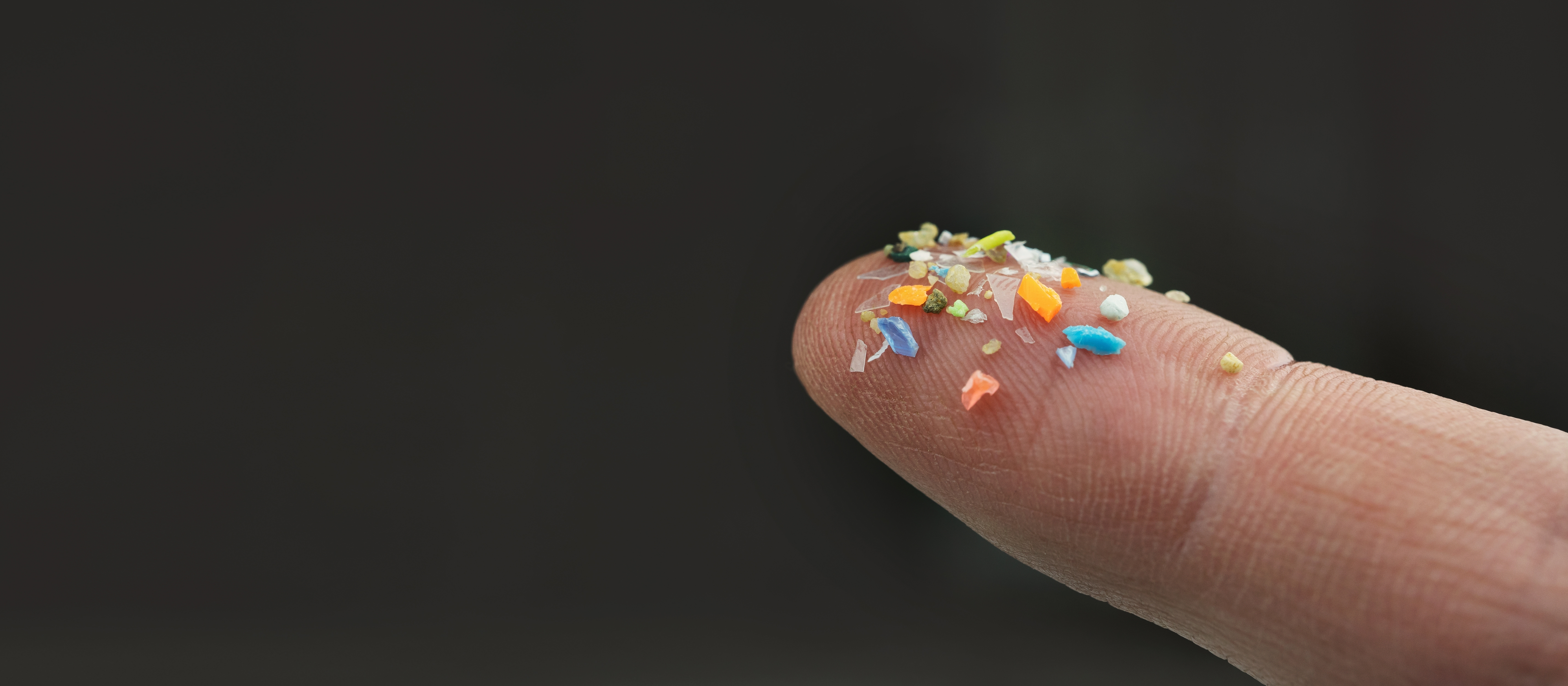 Macro,Shot,Of,Microplastics,On,A,Human,Finger.,Concept,Of