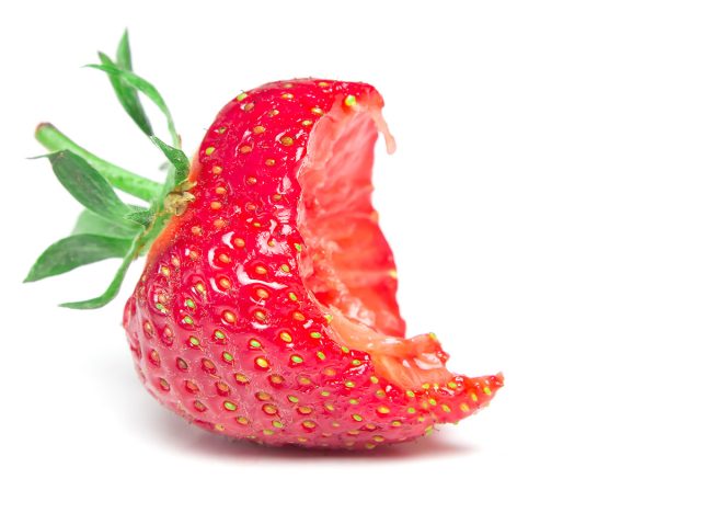 Bite strawberry on a white background