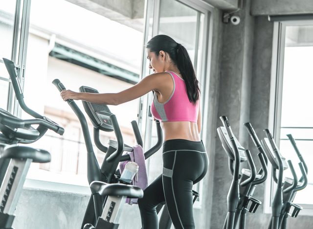 Female is working out on Step climber machine in fitness gym for healthy lifestyle concept