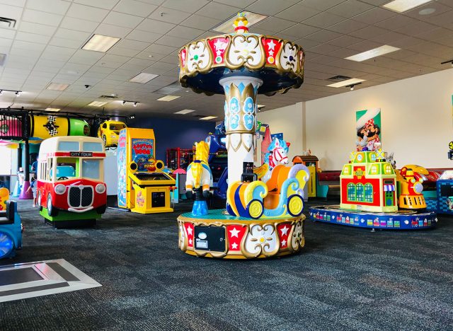 Empty young kids rides inside Chuck E Cheese's location.