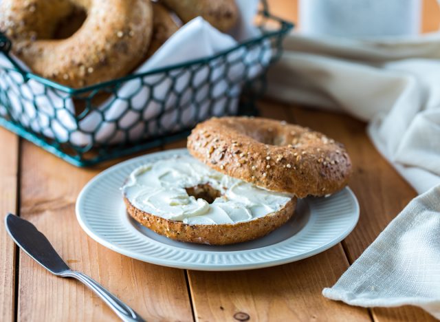 A multigrain bagel with cream cheese.