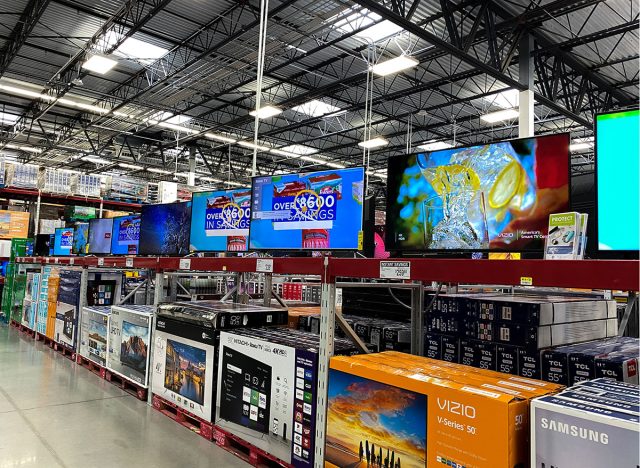 The TV aisle of a Sams Club Wholesale retail store with a variety of television ready to be purchased by consumers.