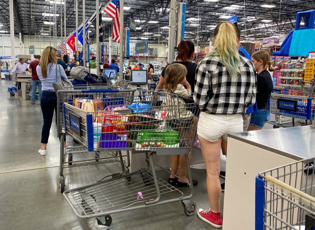 Customers standing in long lines waiting to check out their groceries at a Sams Club in Orlando, Florida 