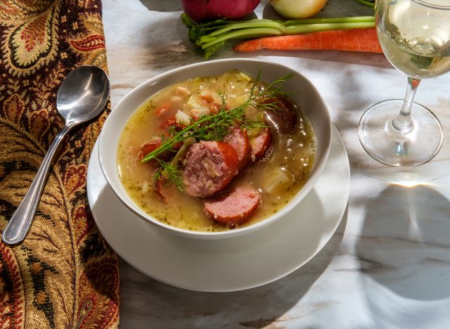 German kielbasa Oktoberfest stew with cabbage potatoes and a glass of white wine