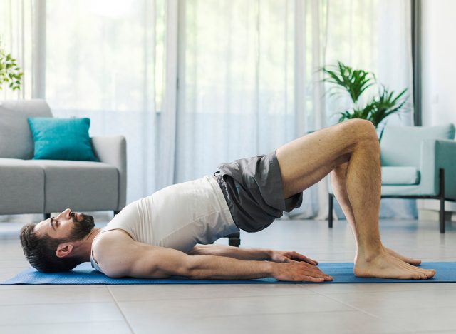 Athletic man exercising at home, fitness and sports concept