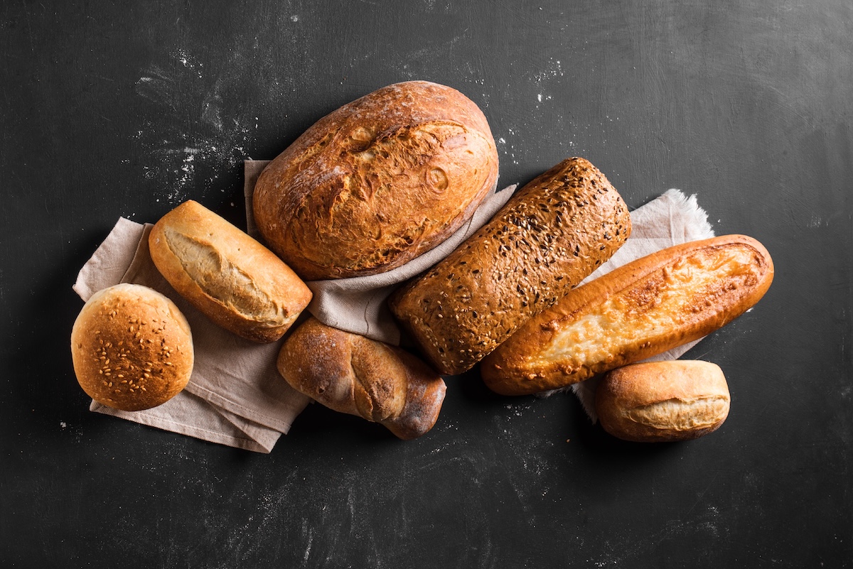 Assortment,Of,Various,Delicious,Freshly,Baked,Bread,On,Black,Background.