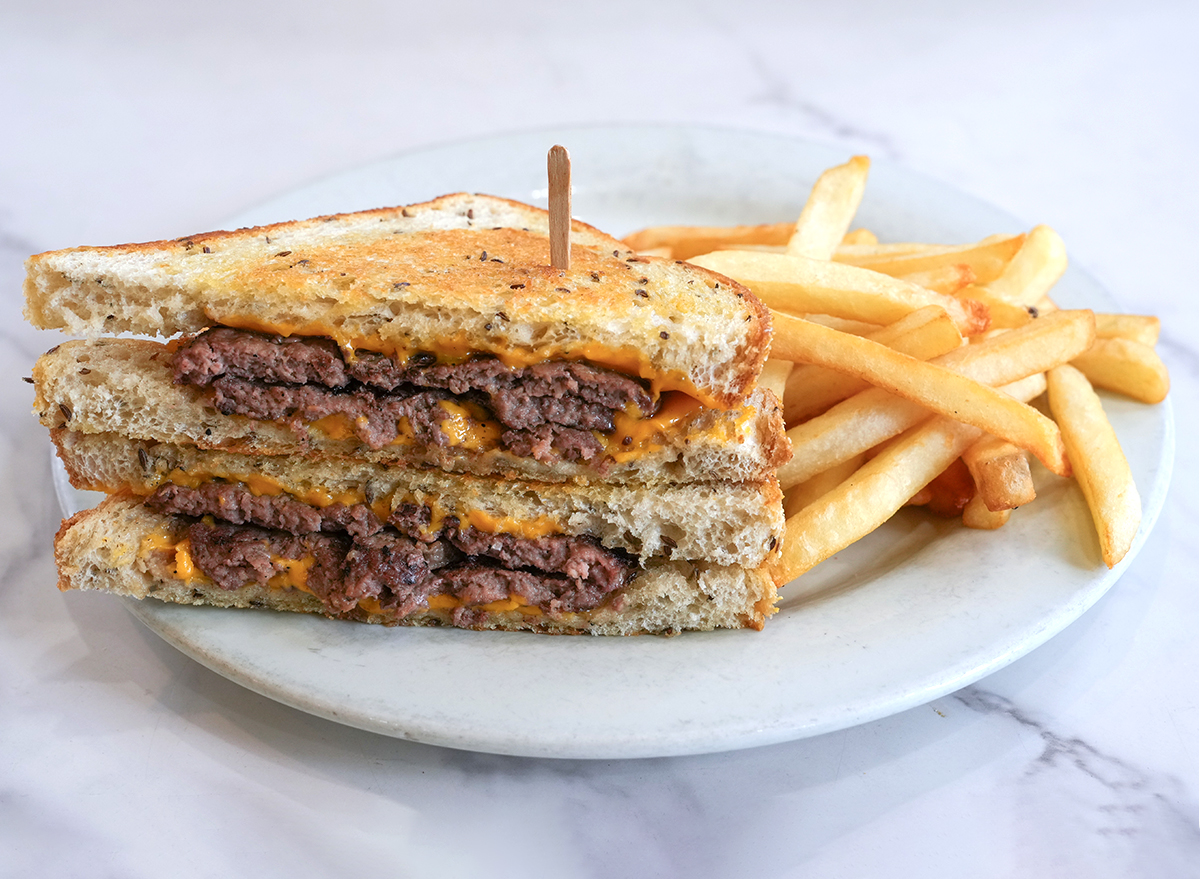 patty melt on a white marble background