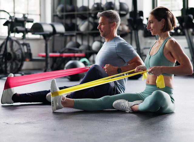 Elastic Stretch Band Training Exercise. Pilates Workout In Gym, resistance band rows