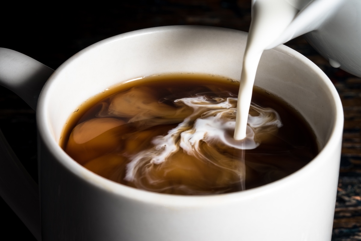 Pouring,Cream,Into,A,Cup,Of,Coffee