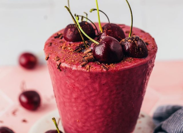 Chocolate Cherry Protein Shake in a glass with cherries on top