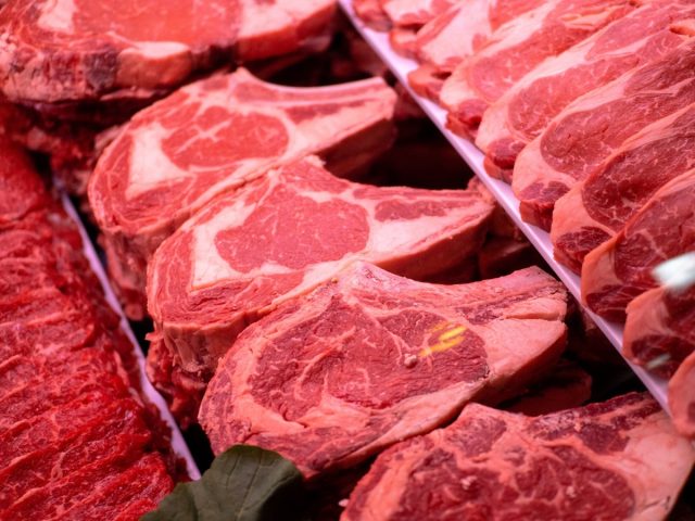 a variety of red meat cuts, likely beef, presented for sale