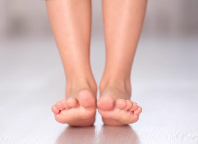 child rolls from heel to toe. Prevention of flat feet in children. Exercises for the legs. Flat feet physical therapy. close up, heel toe rockers