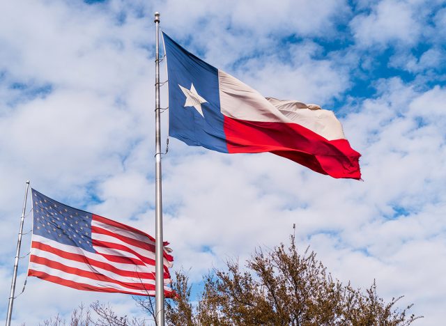 America Flag and Lone Star Texas State Flag waving in the wind 