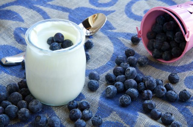 Natural yogurt with blueberries on a decorative sackcloth